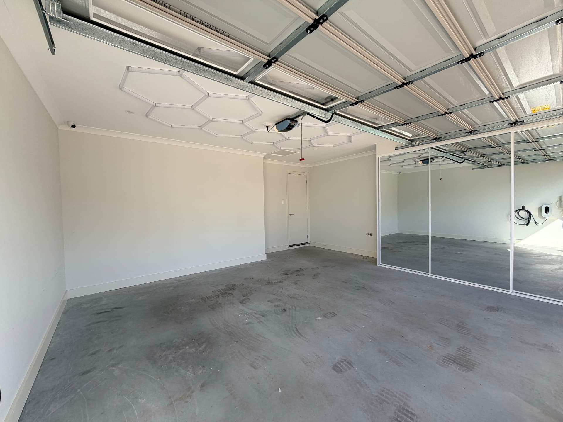 Bare stained concrete garage slab before epoxy flooring